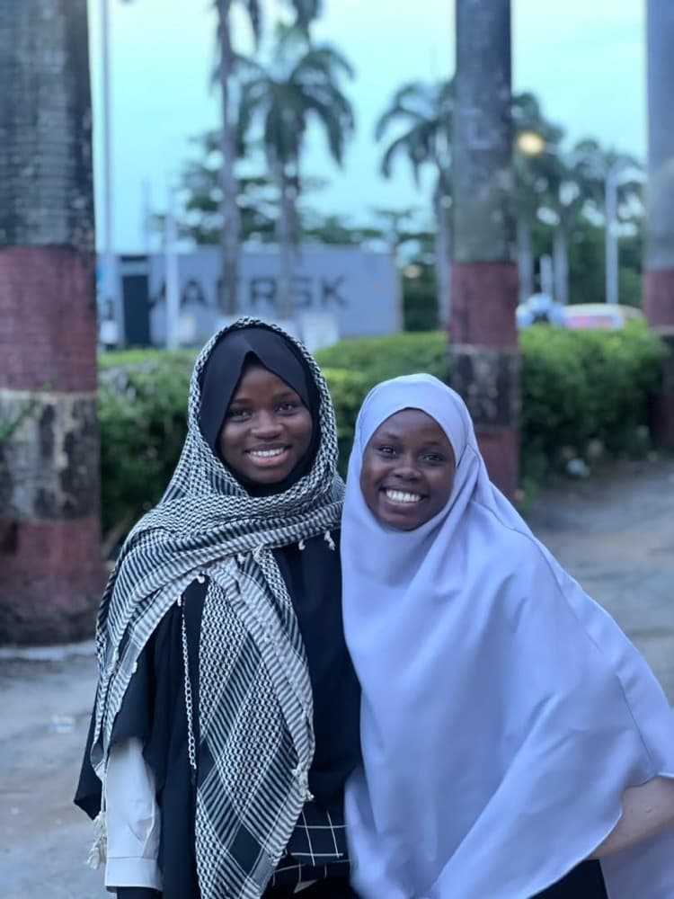 Two sisters smiling together at the end of the session