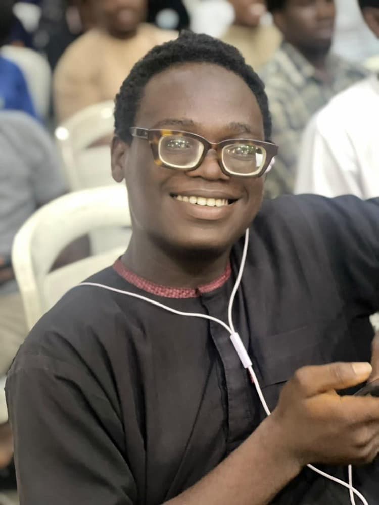 A brother smiling at a programme