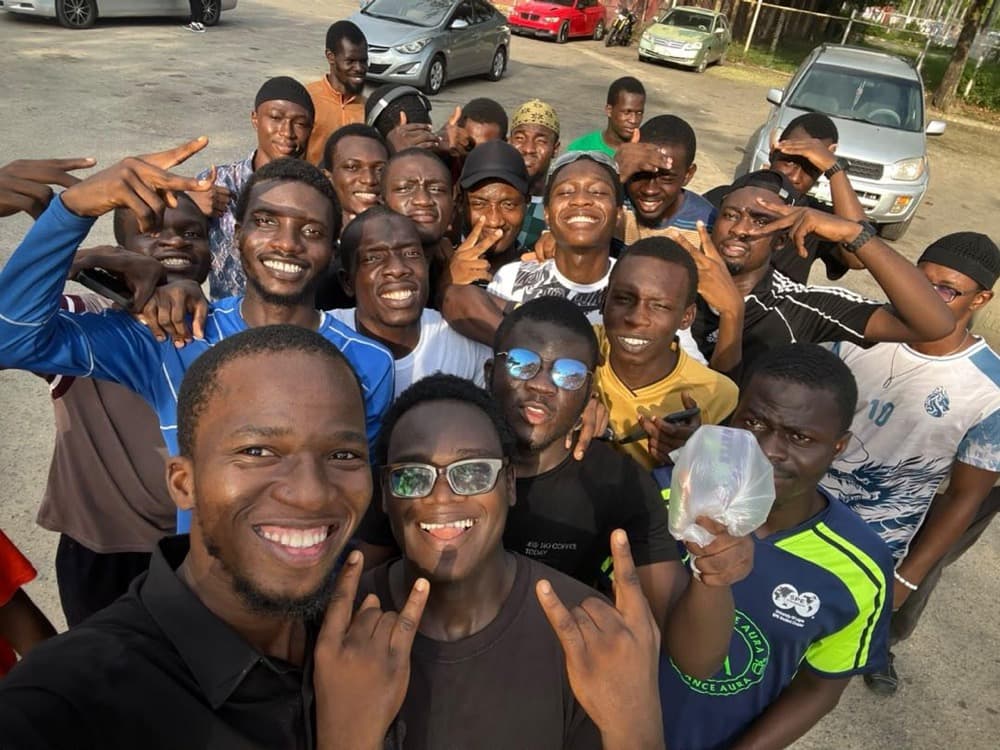 A big group of brothers cheering in a selfie