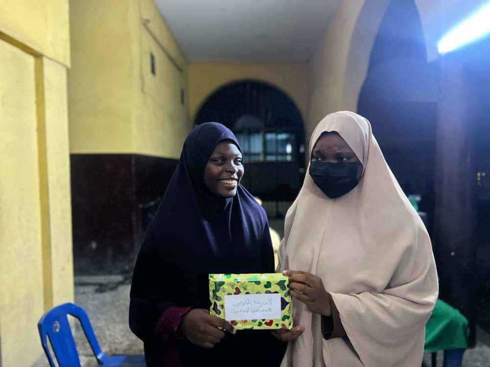 A sister receiving her prize at the Modrasah prize-giving